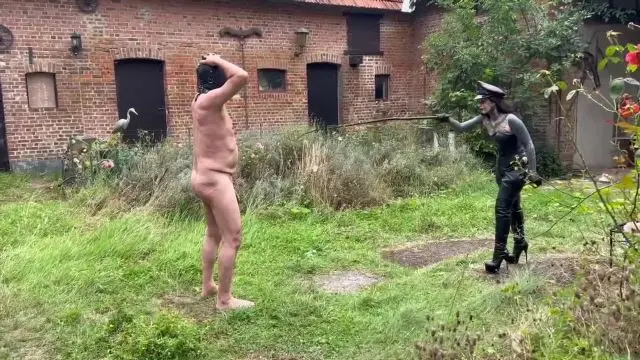 Poster: Mistress Lunatika: mistress whipping male - Outdoor Bullwhip Session